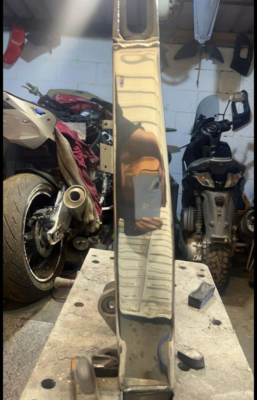 Polished motorcycle swingarm ready for finishing